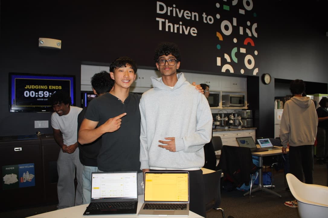 Posing with laptops at a hackathon judging round